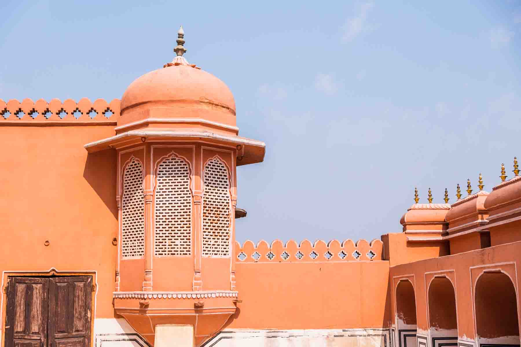 A pink domed turret rising from a Jaipur rooftop