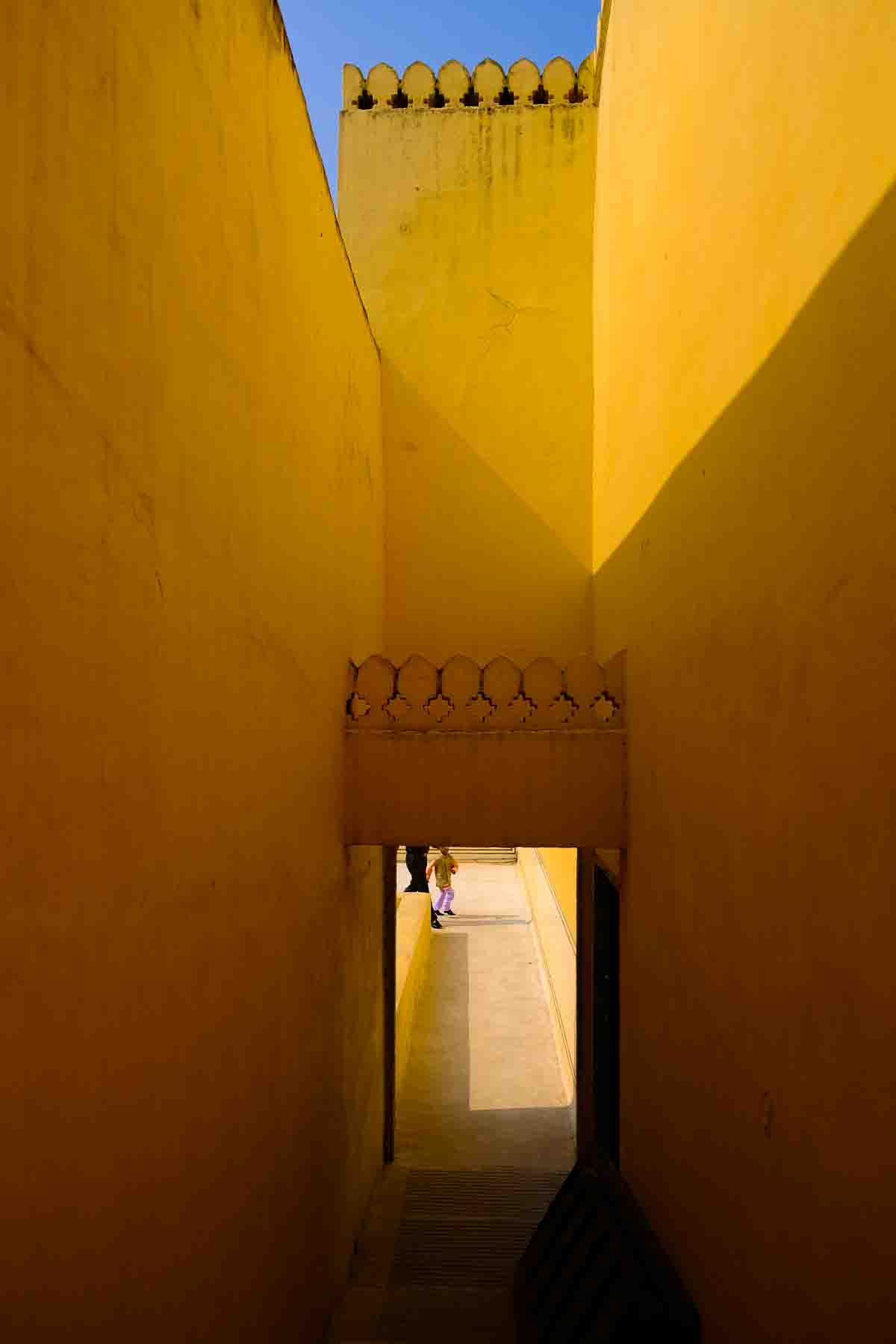 Yellow-washed passage walls inside a Jaipur fort