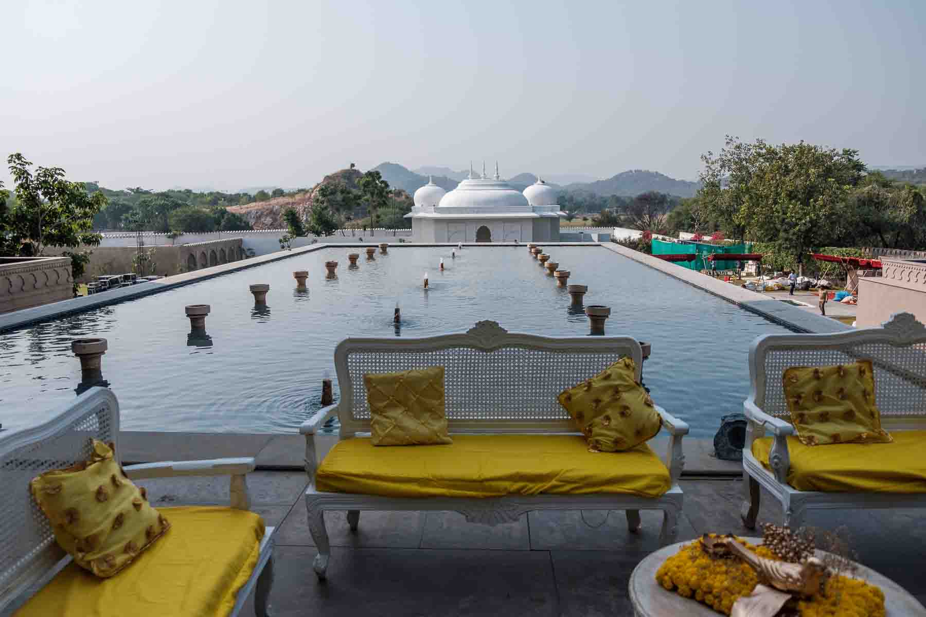 A white marble pavilion mirrored in a still reflecting pool