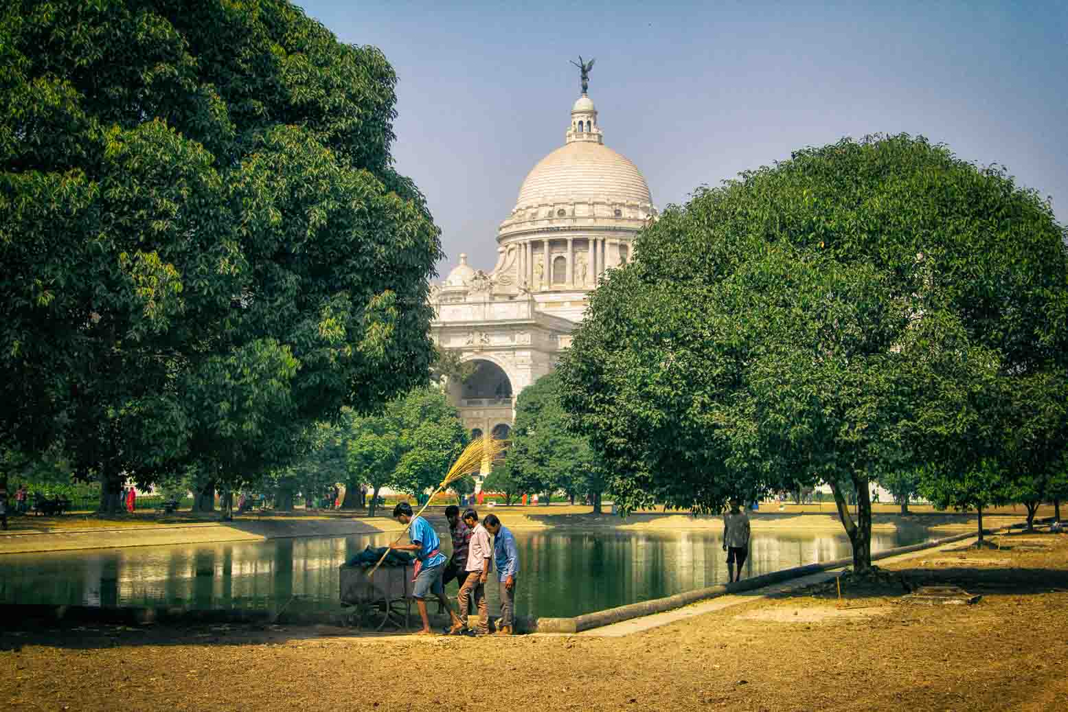 The white dome of the Victoria Memorial above the treetops
